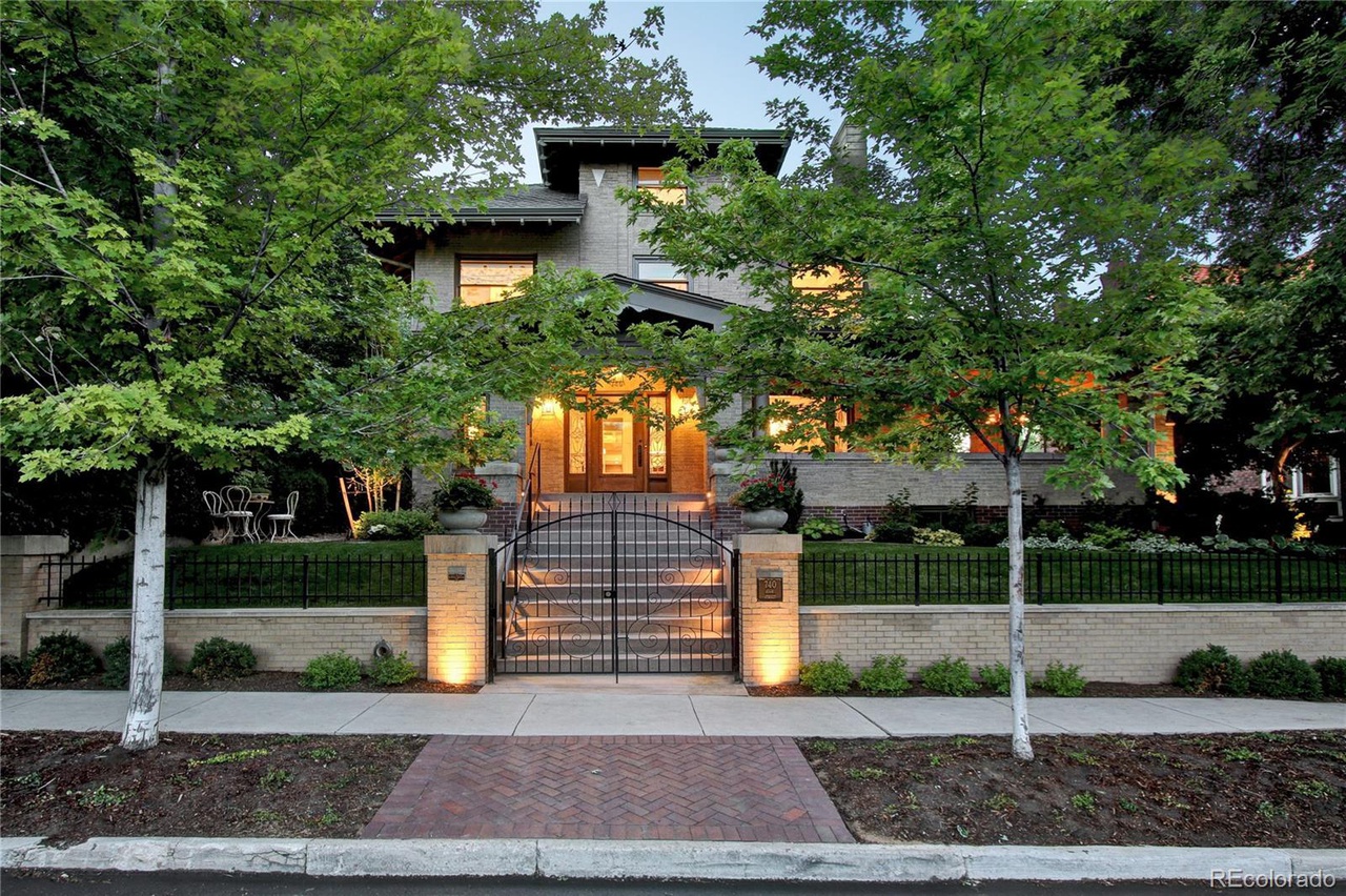 Gated house entrance with illuminated windows