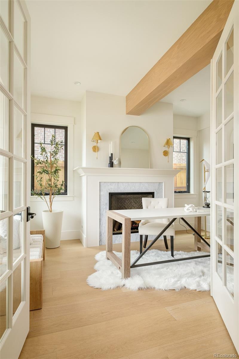 Bright home office with fireplace and desk