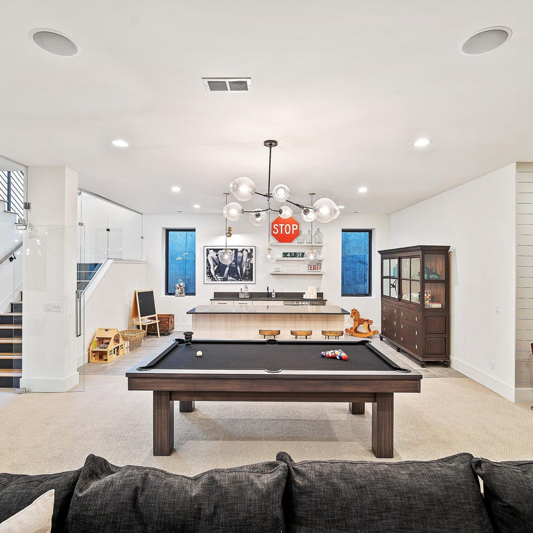 Modern basement game room with pool table